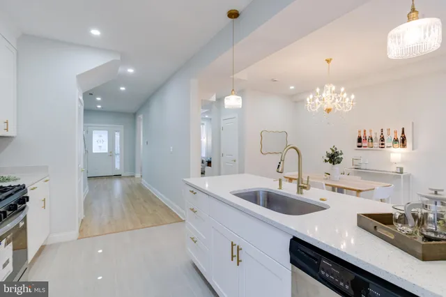 a spacious bathroom with a granite countertop sink a mirror and a shower