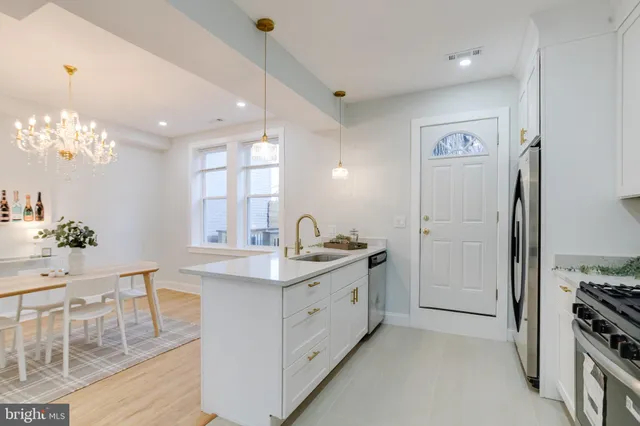 a view of a dining room with furniture and chandelier