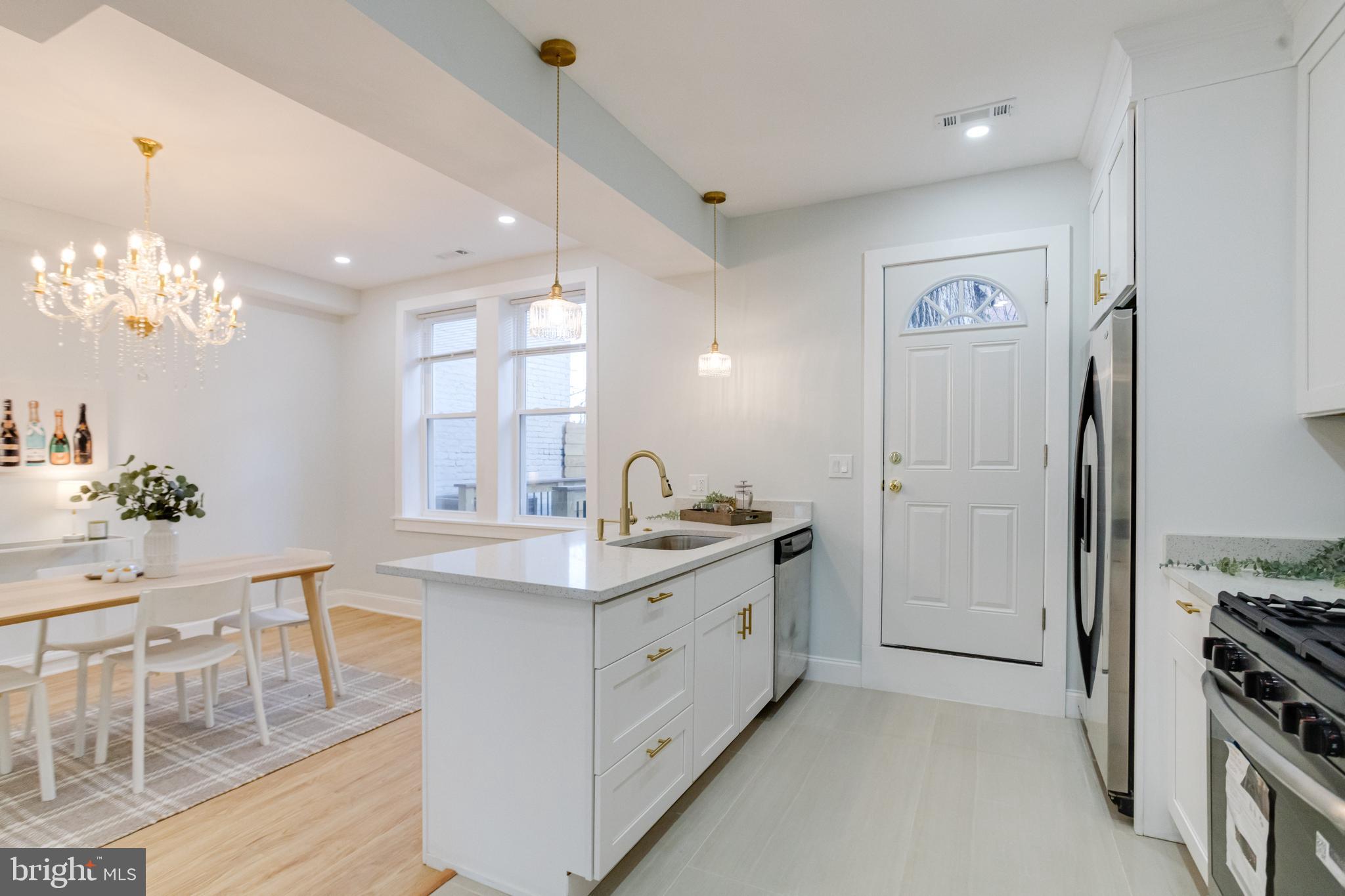 635 North Rosedale Street Baltimore, MD 21216 - Photo 7 of 64 a spacious bathroom with a granite countertop sink a mirror and a shower