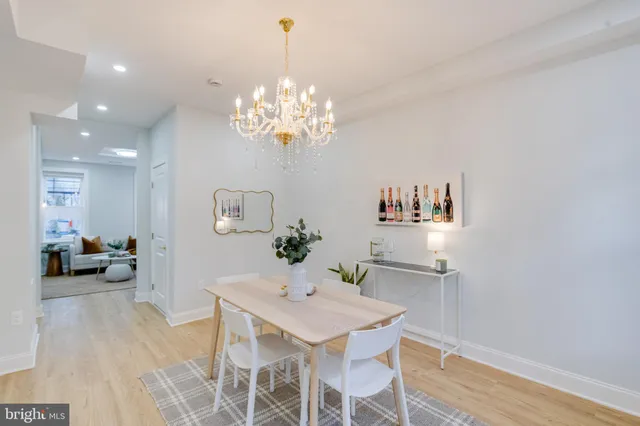 a view of a dining room with furniture and chandelier