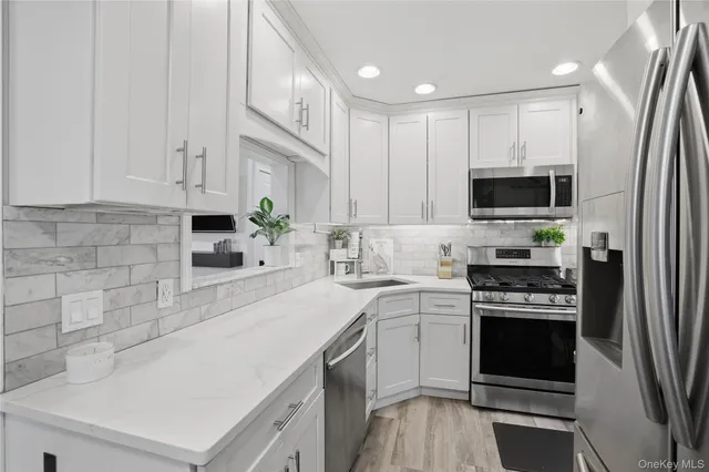 a kitchen with a sink stove top oven and refrigerator