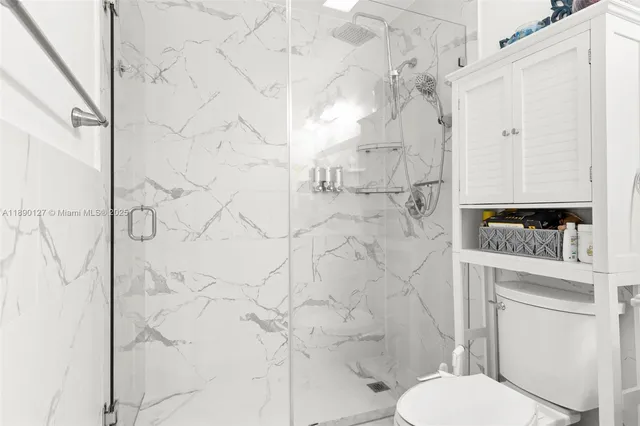 a bathroom with a toilet and a shower