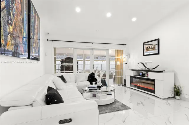 a living room with furniture a flat screen tv and a large window