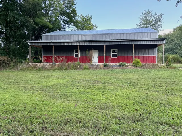 a view of a house with a yard and sitting area