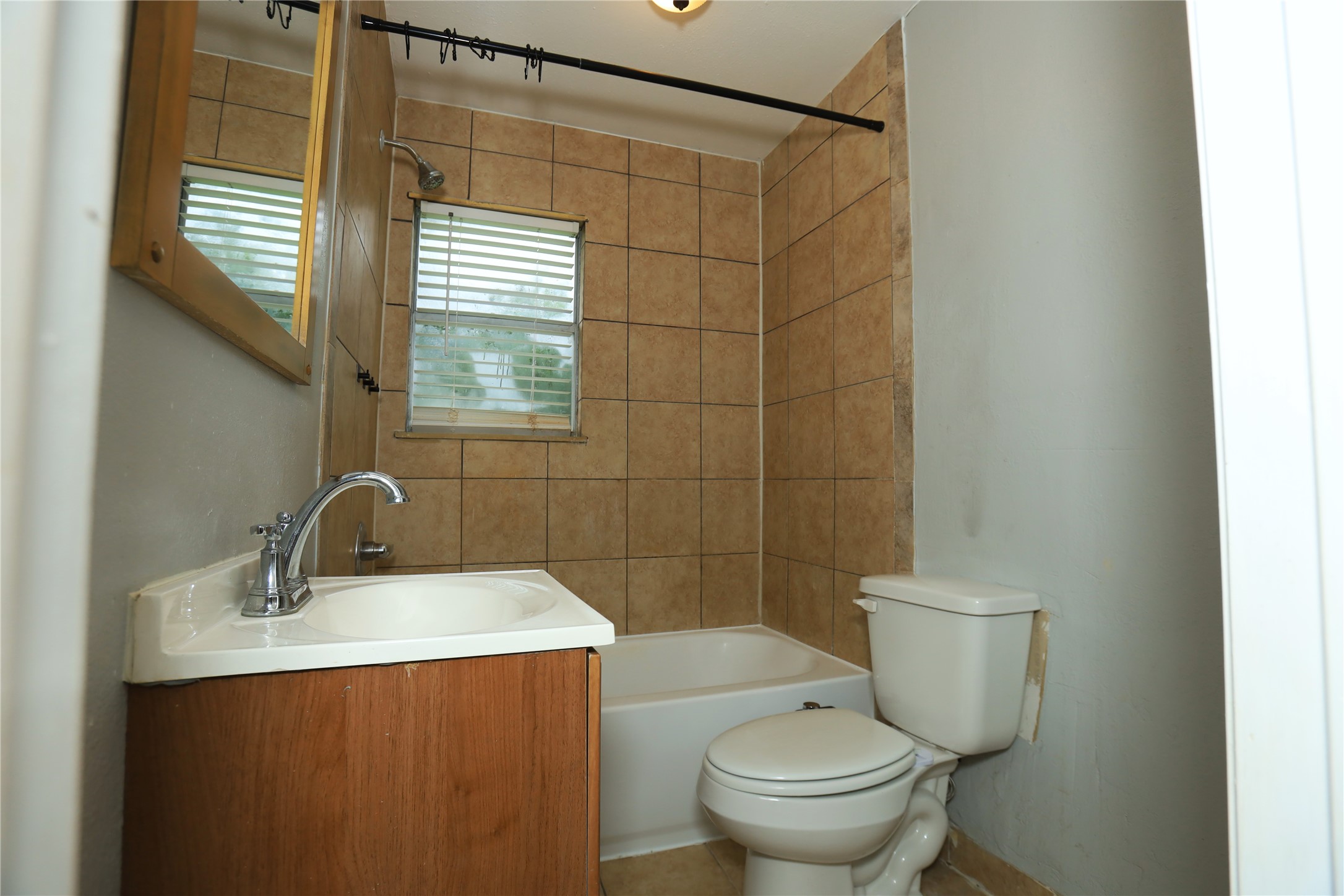 713 South Valderas Street Angleton, TX 77515 - Photo 7 of 10 a bathroom with a sink a toilet and shower