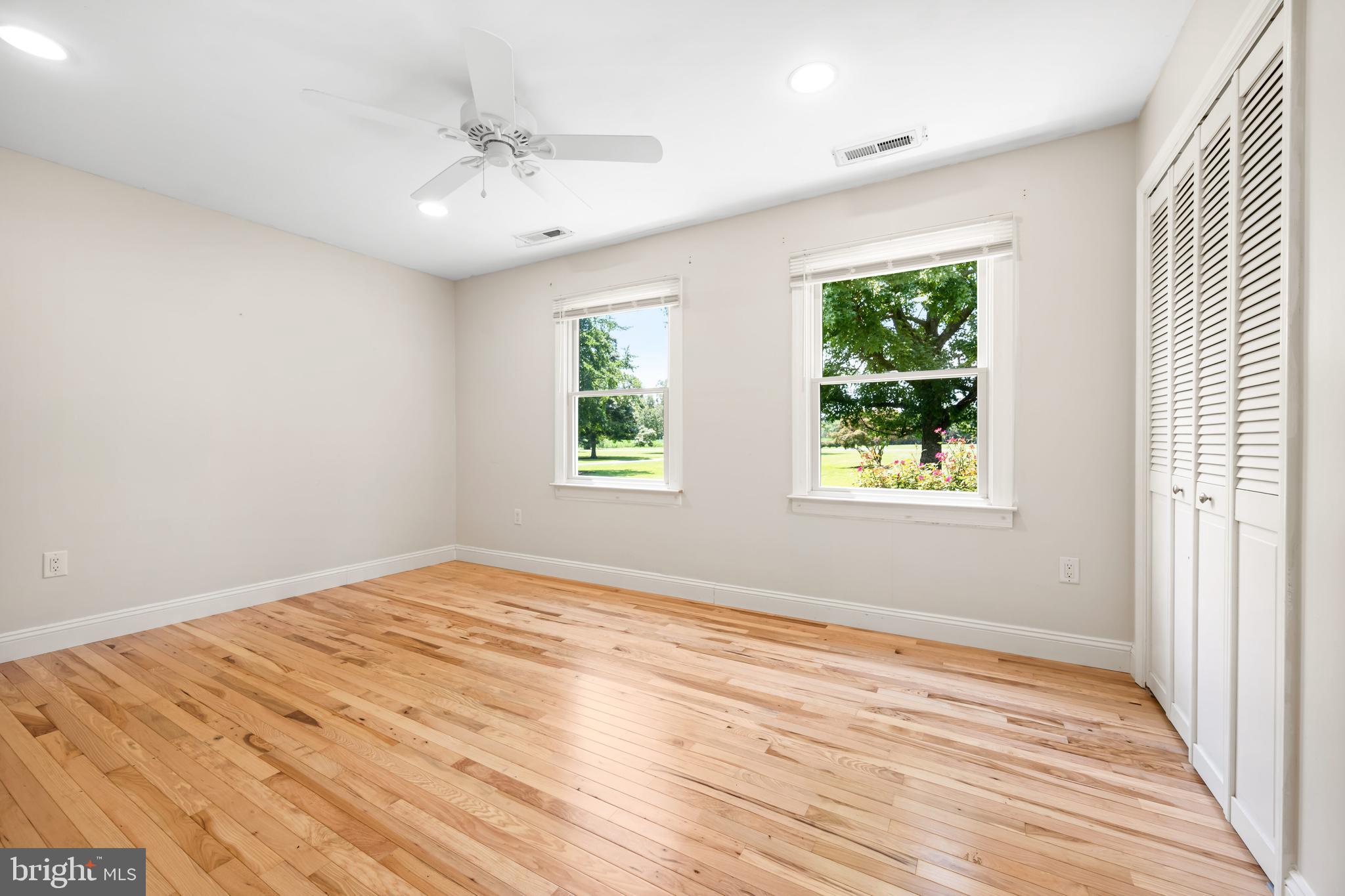 26648 Arcadia Shores Road Easton, MD 21601 - Photo 16 of 25 an empty room with wooden floor and windows