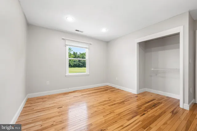 a view of a room with wooden floor and window