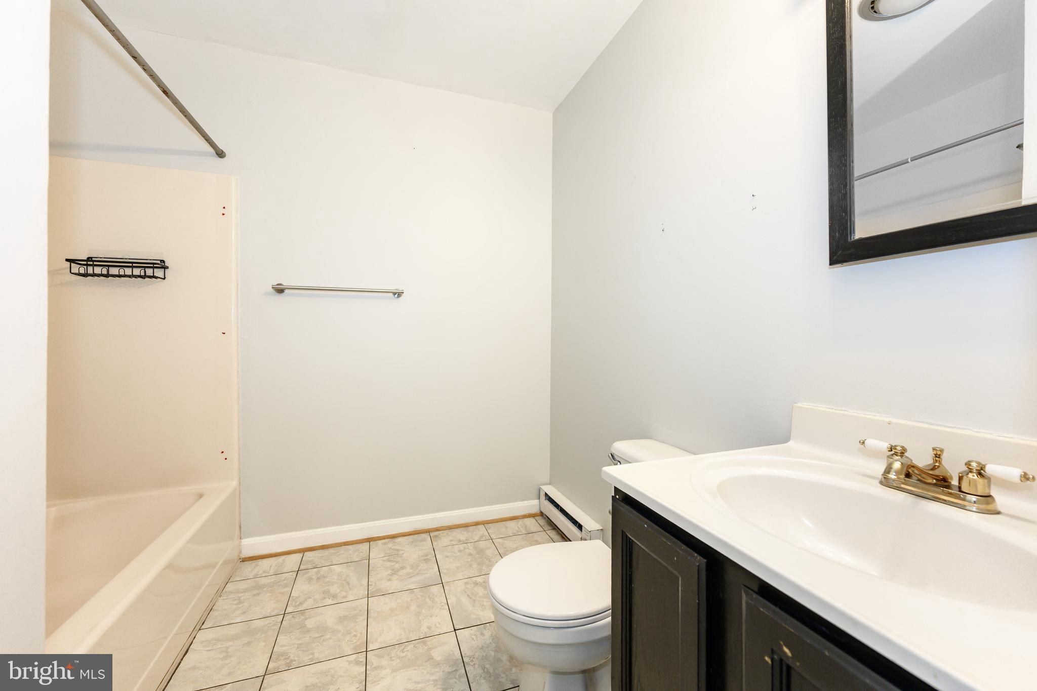 26648 Arcadia Shores Road Easton, MD 21601 - Photo 21 of 25 a bathroom with a granite countertop sink a toilet and a bathtub