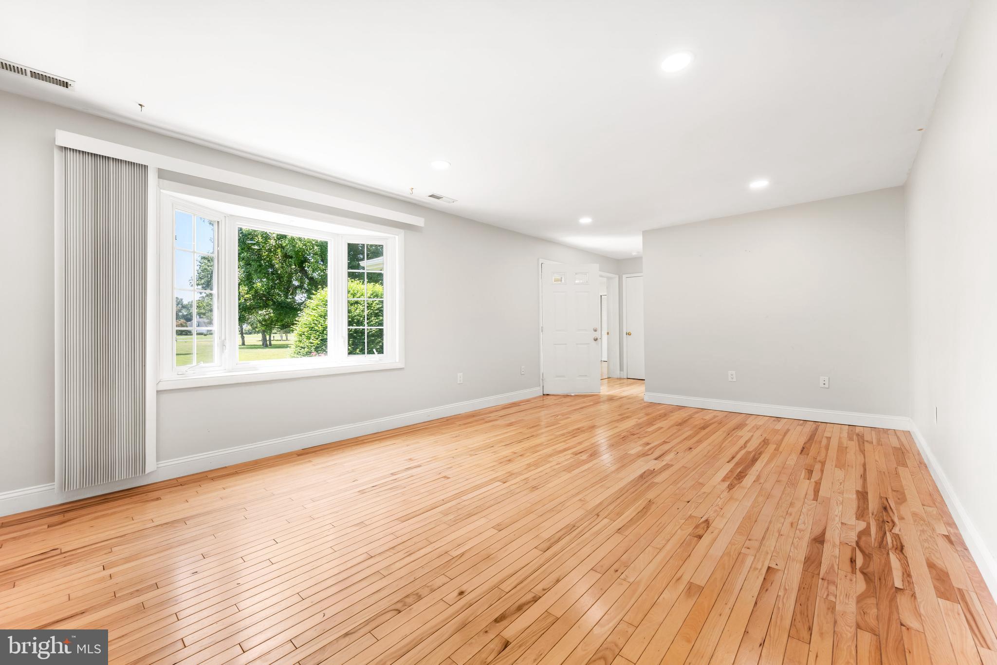 26648 Arcadia Shores Road Easton, MD 21601 - Photo 5 of 25 a view of empty room with wooden floor and fan