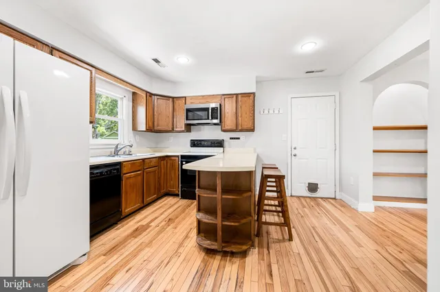 a kitchen with a window a sink and a counter top space