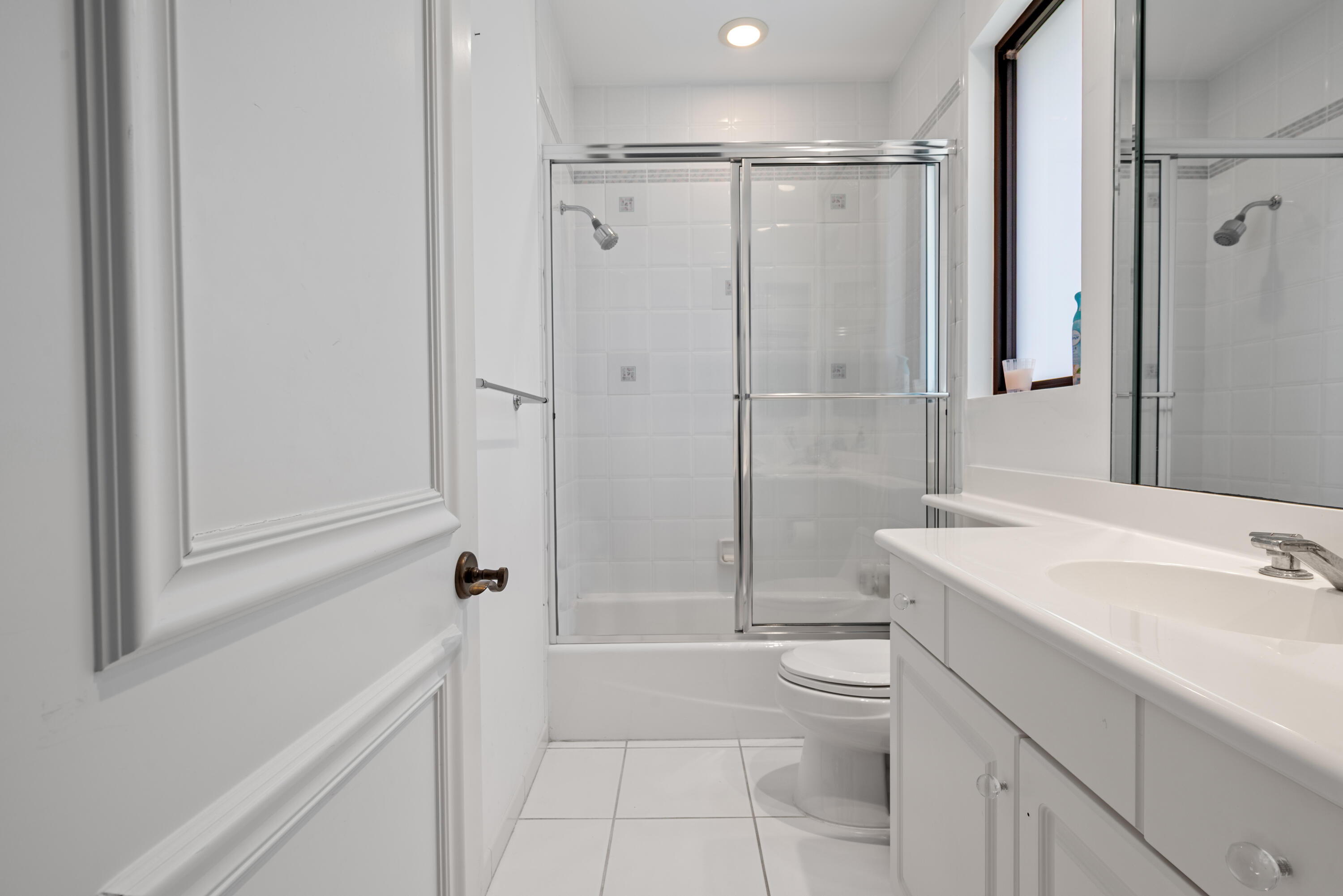18800 Long Lake Drive Boca Raton, FL 33496 - Photo 57 of 60 a bathroom with a sink a toilet and shower