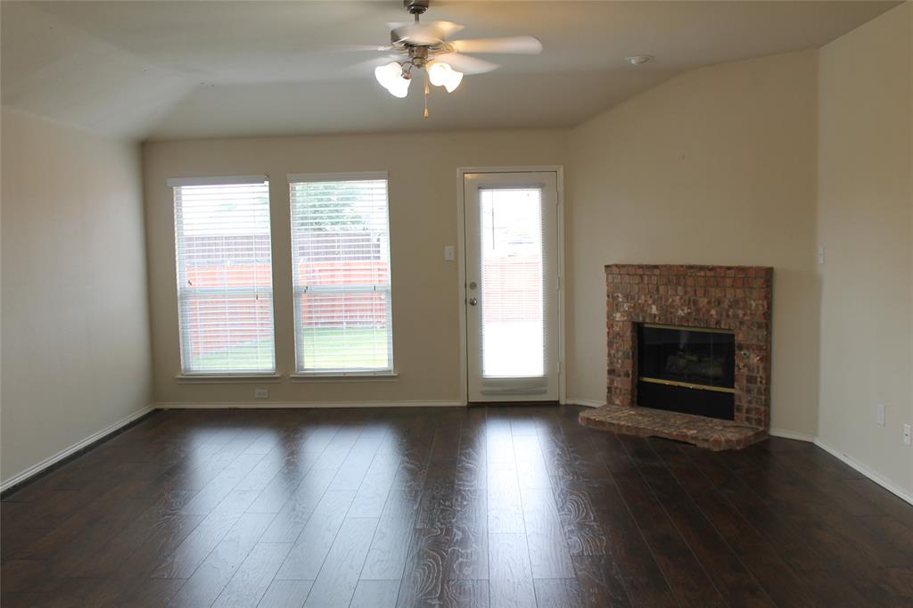 4188 Cherry Ridge Drive Frisco, TX 75033 - Photo 8 of 25 a view of an empty room with wooden floor fireplace and a window