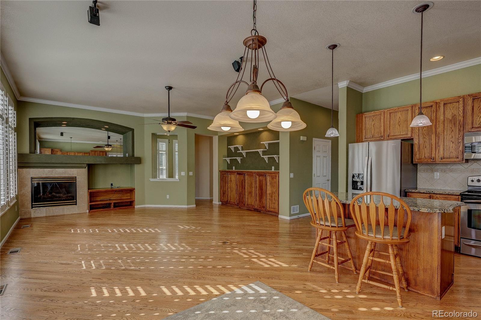 10292 South Nickolas Avenue Highlands Ranch, CO 80124 - Photo 11 of 46 a view of a room with furniture and a chandelier