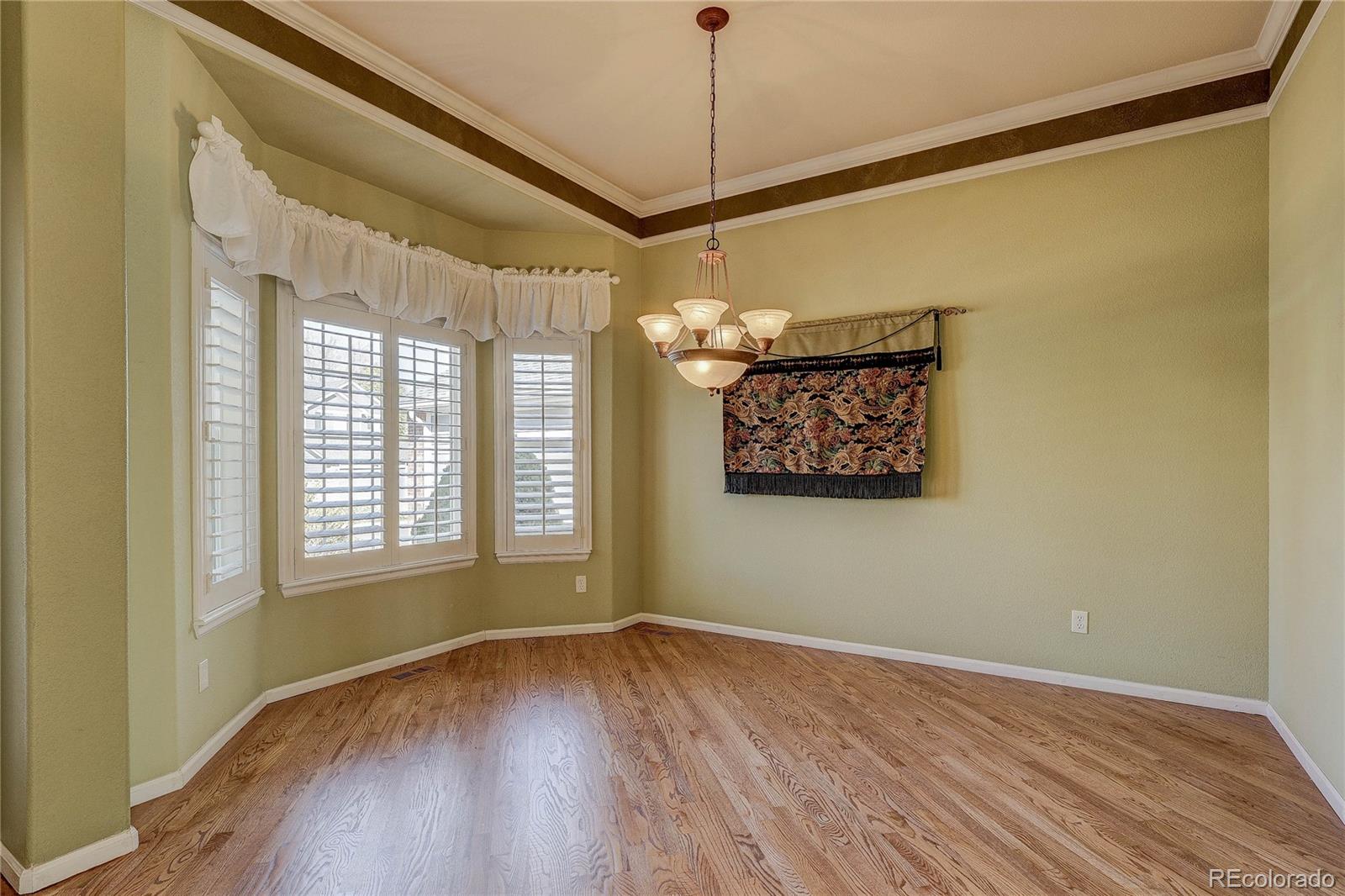 10292 South Nickolas Avenue Highlands Ranch, CO 80124 - Photo 15 of 46 a view of a room with window and wooden floor