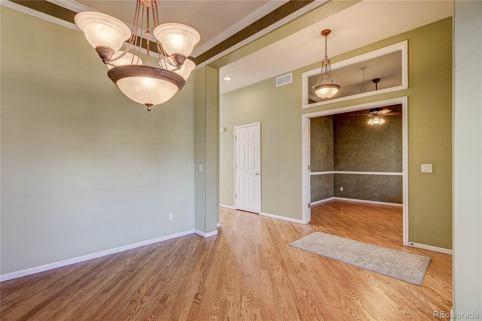 10292 South Nickolas Avenue Highlands Ranch, CO 80124 - Photo 16 of 46 a view of a hallway with wooden floor