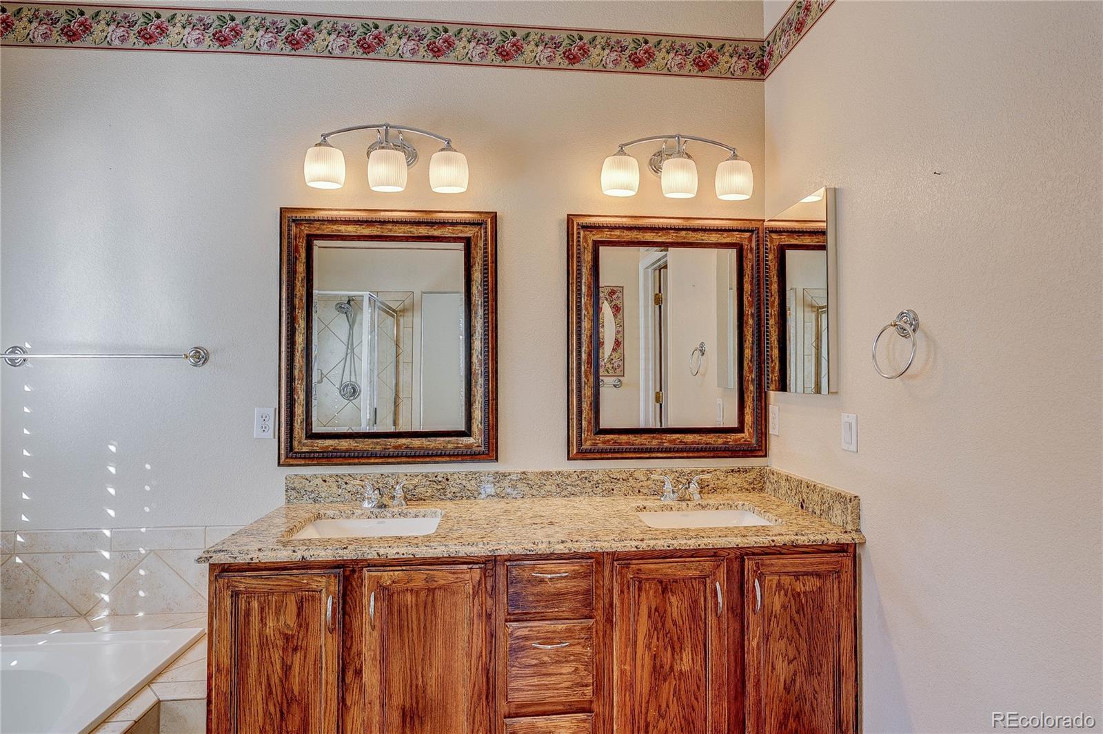 10292 South Nickolas Avenue Highlands Ranch, CO 80124 - Photo 22 of 46 a bathroom with mirror a sink and a mirror