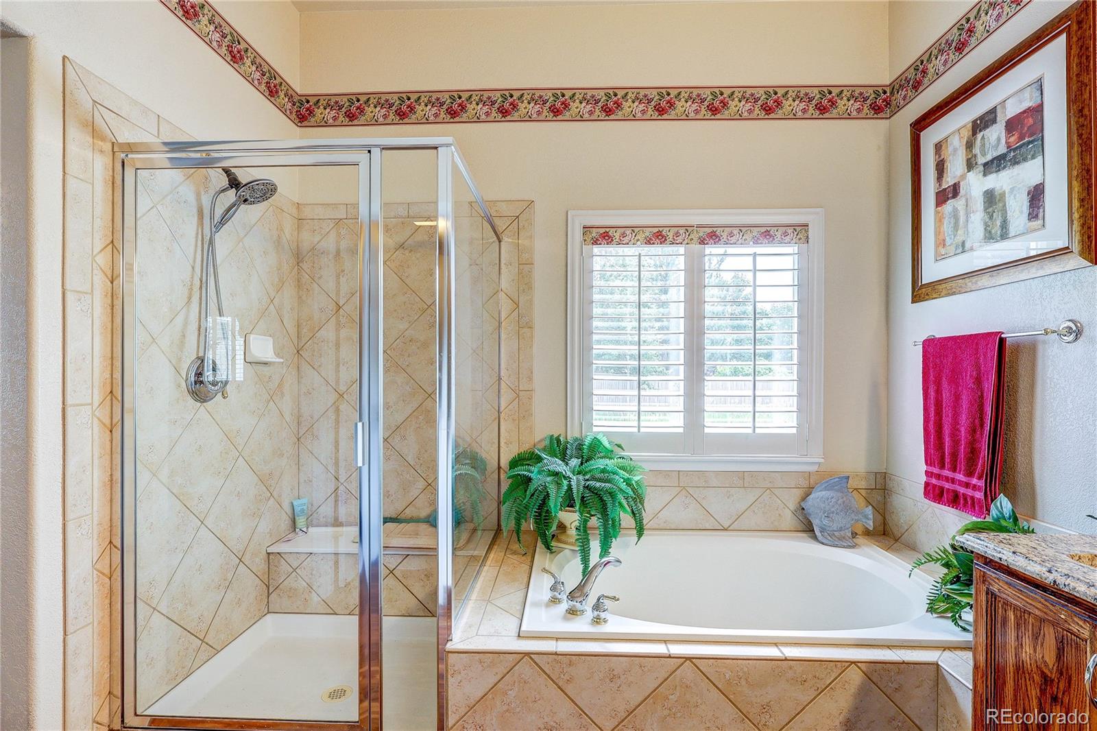 10292 South Nickolas Avenue Highlands Ranch, CO 80124 - Photo 25 of 46 a bath tub sitting next to a blue shower