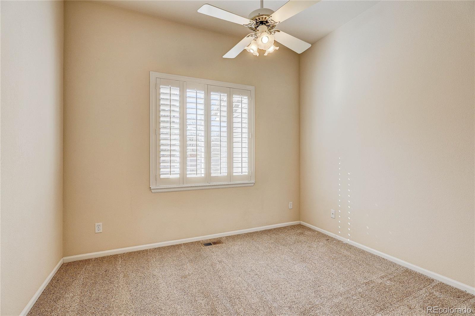 10292 South Nickolas Avenue Highlands Ranch, CO 80124 - Photo 27 of 46 an empty room with a window and a fan