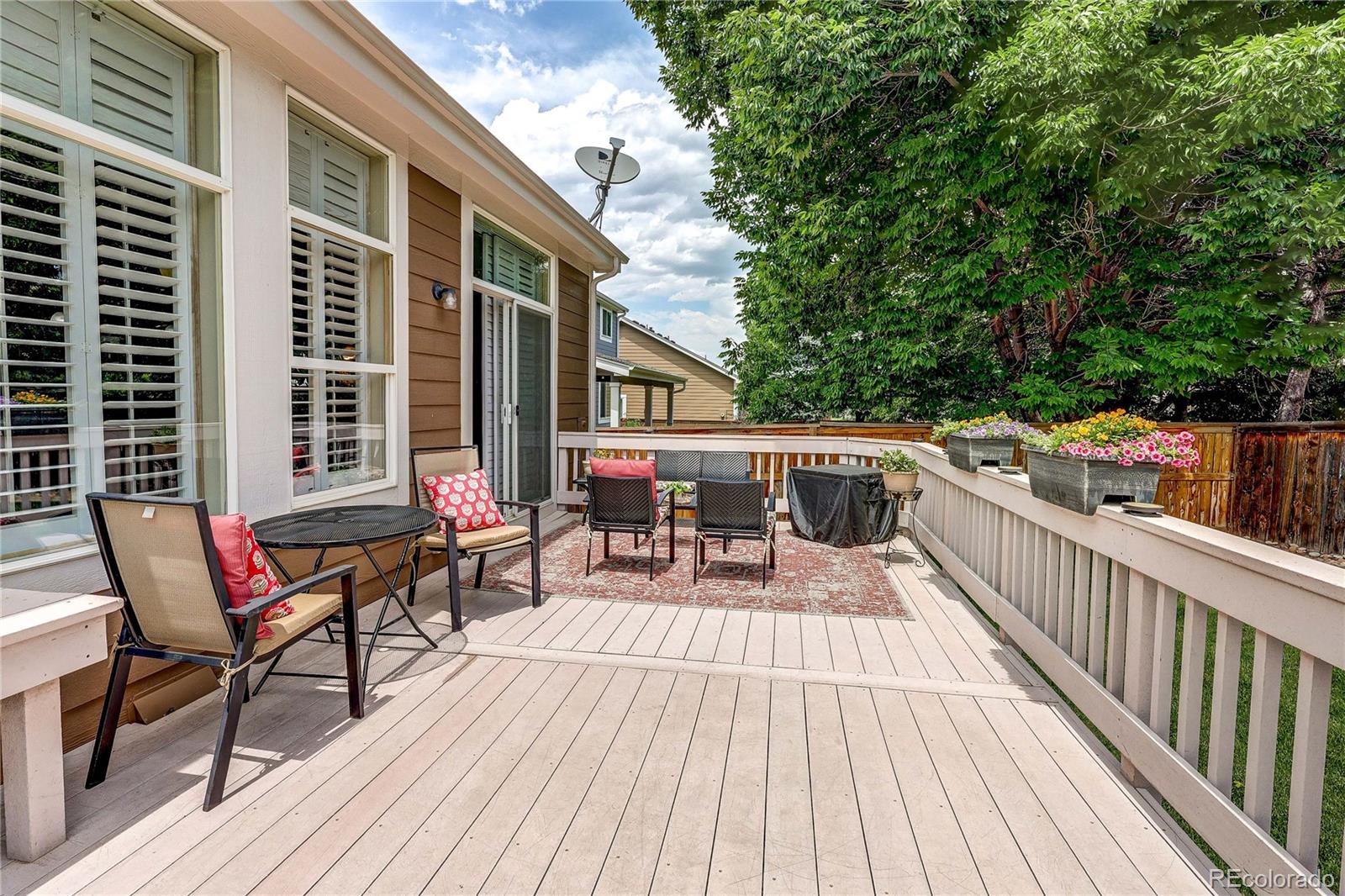 10292 South Nickolas Avenue Highlands Ranch, CO 80124 - Photo 33 of 46 a view of a roof deck with table and chairs and wooden floor
