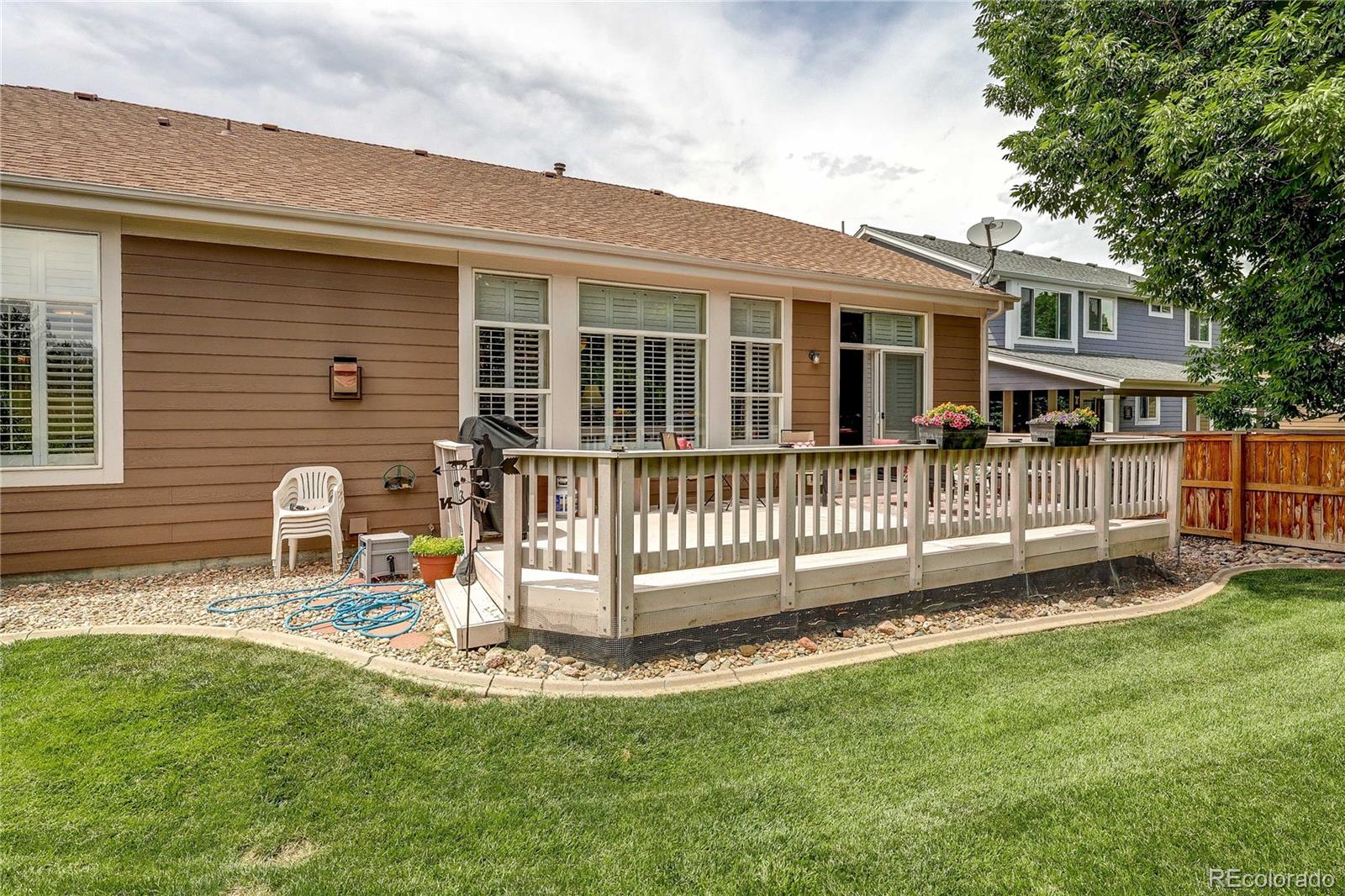 10292 South Nickolas Avenue Highlands Ranch, CO 80124 - Photo 34 of 46 a front view of a house with a yard table and chairs
