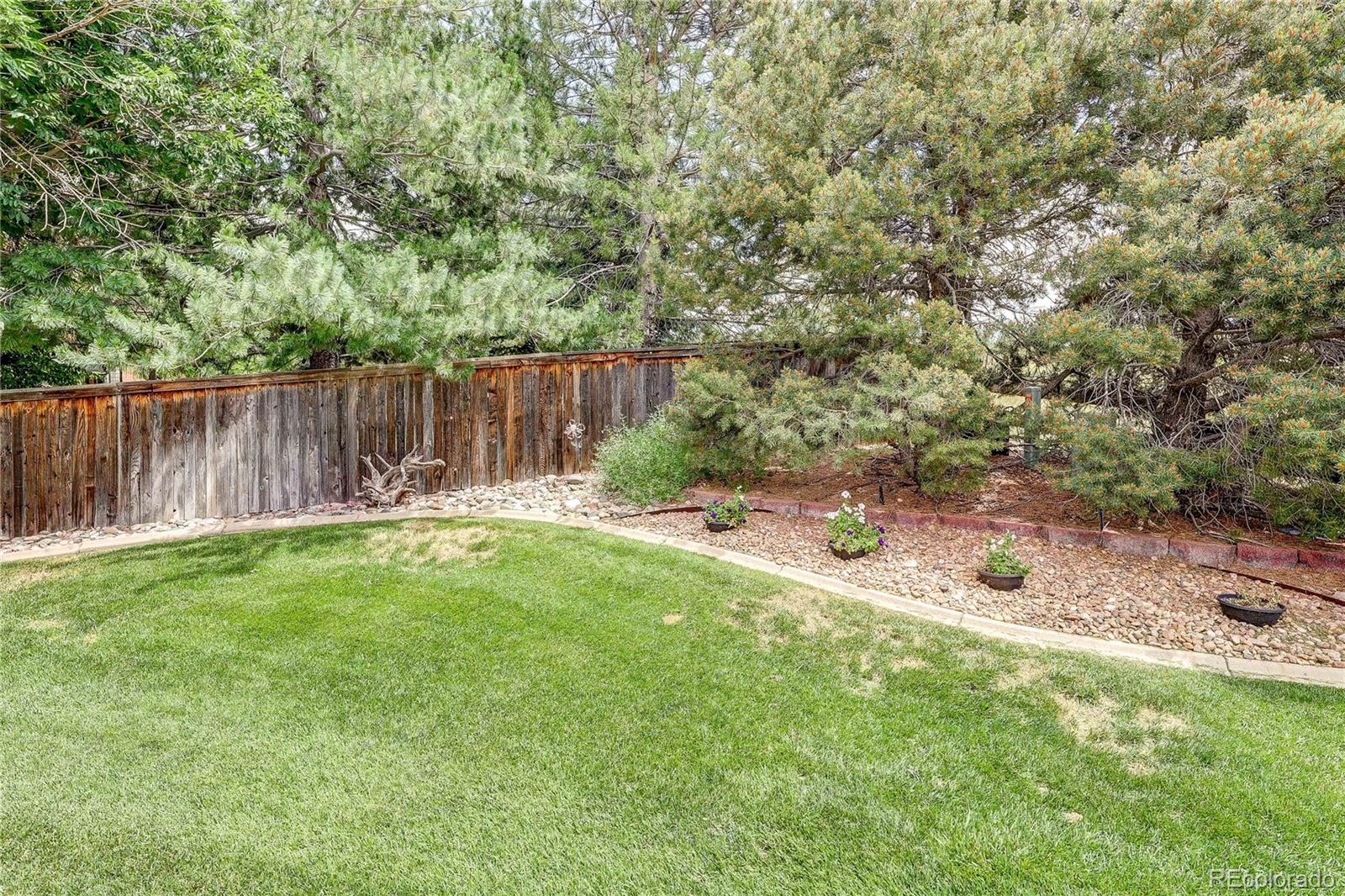 10292 South Nickolas Avenue Highlands Ranch, CO 80124 - Photo 35 of 46 a view of a backyard with a small cabin and a chair