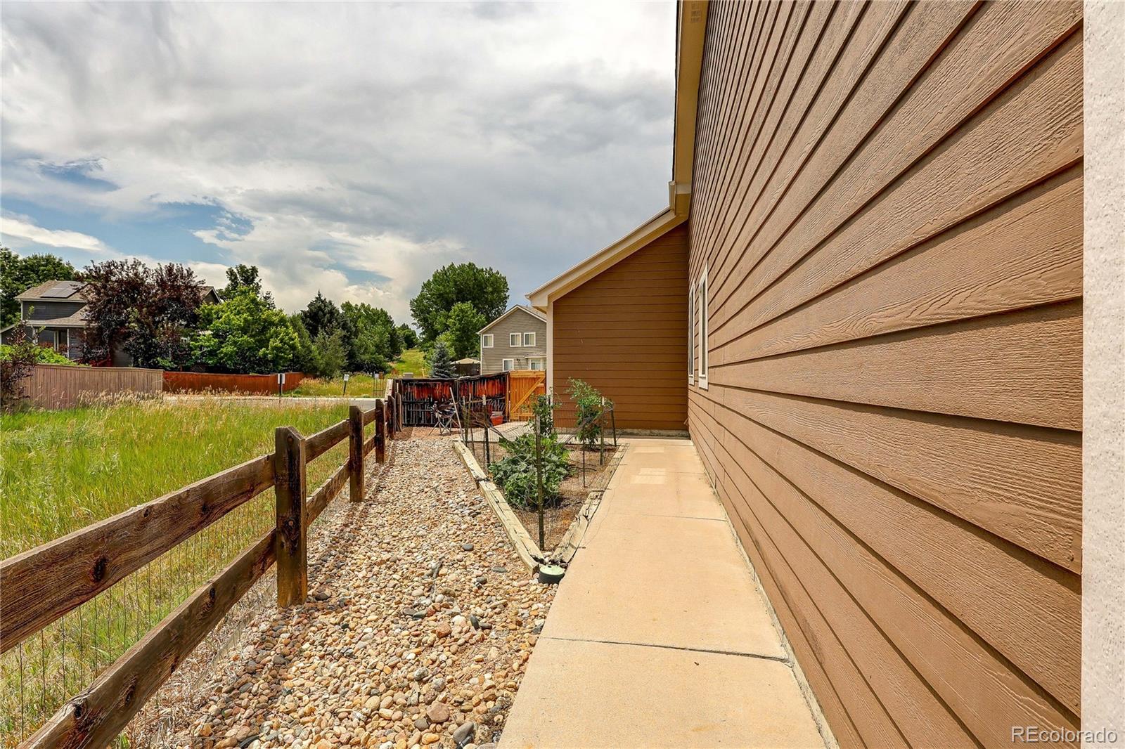 10292 South Nickolas Avenue Highlands Ranch, CO 80124 - Photo 41 of 46 a view of a balcony with wooden floor and fence