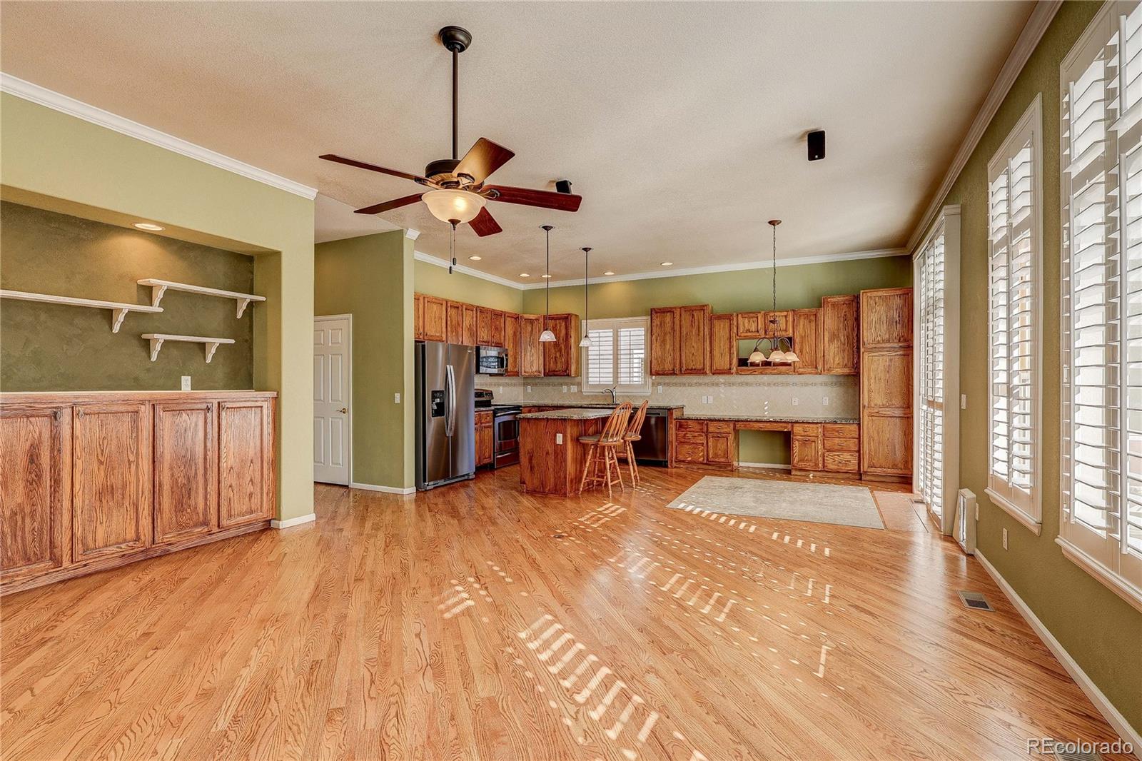 10292 South Nickolas Avenue Highlands Ranch, CO 80124 - Photo 8 of 46 a large room with kitchen island