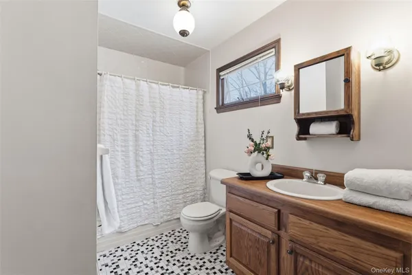 a bathroom with a sink toilet and shower