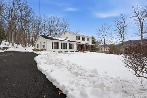 a view of residential houses with snow on the road