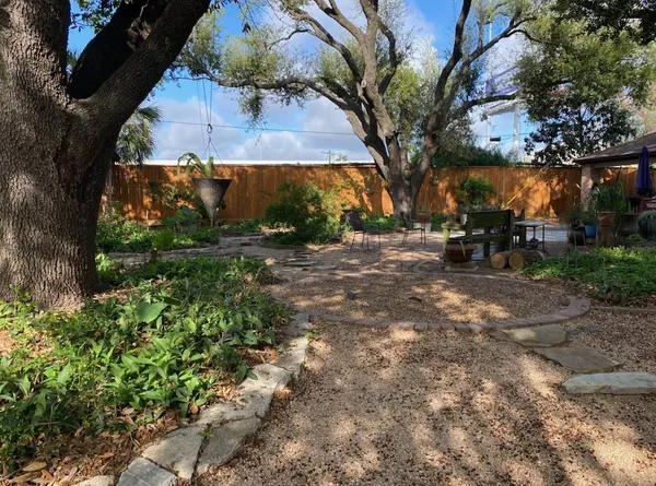 a view of backyard with outdoor seating and green space