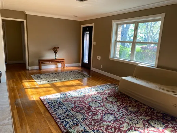 a living room with a rug table and a couch
