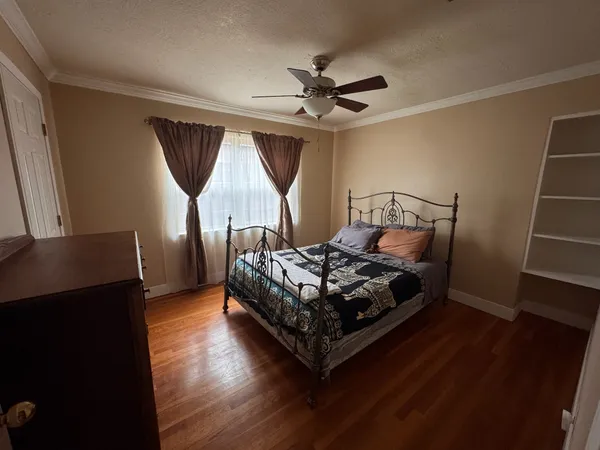 a bed sitting in a bedroom next to a window