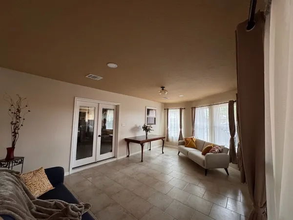 a living room with furniture and a large window