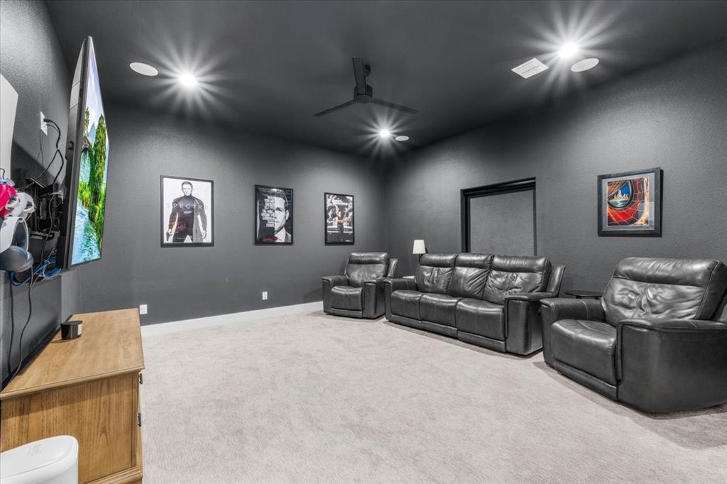 1059 Sweeney Way Weatherford, TX 76087 - Photo 18 of 37 Media room is carpeted room dark gray walls and ceiling, featuring recessed lighting, a ceiling fan, blackout roller shade and closet.