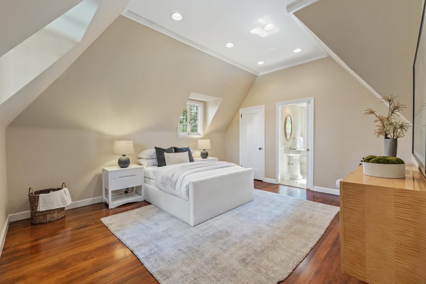 460 Edgewood Road San Mateo, CA 94402 - Photo 18 of 40 a spacious bedroom with a bed and a couch