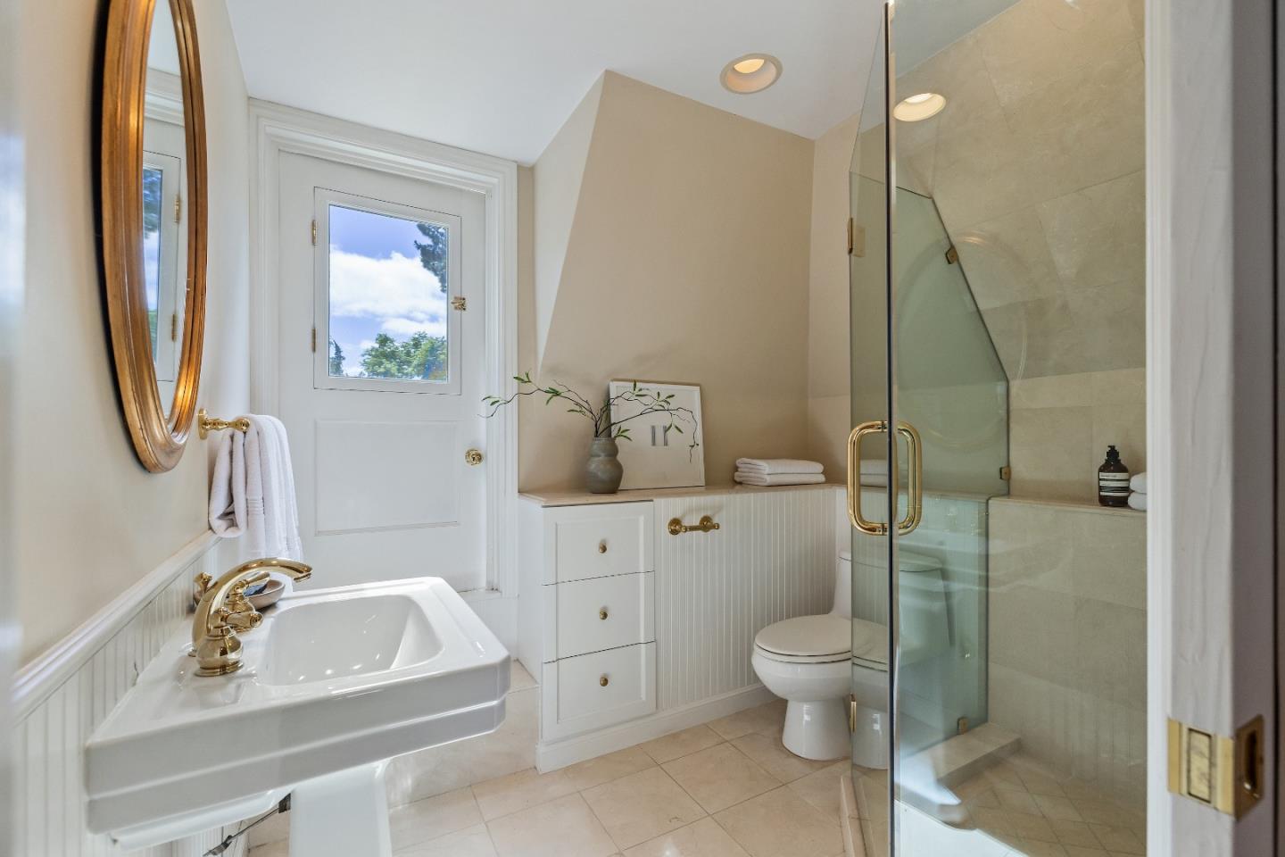 460 Edgewood Road San Mateo, CA 94402 - Photo 19 of 40 a bathroom with a sink a toilet and a mirror