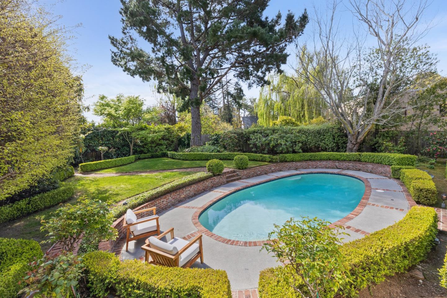 460 Edgewood Road San Mateo, CA 94402 - Photo 27 of 40 a view of a swimming pool and trees in the background