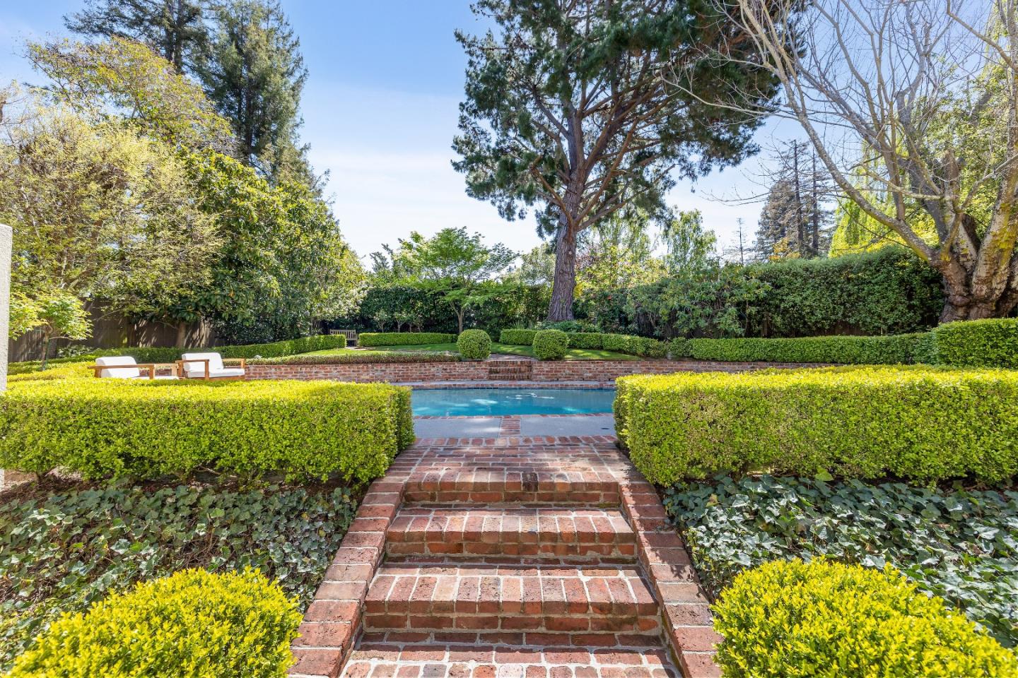 460 Edgewood Road San Mateo, CA 94402 - Photo 35 of 40 a view of a swimming pool with a garden