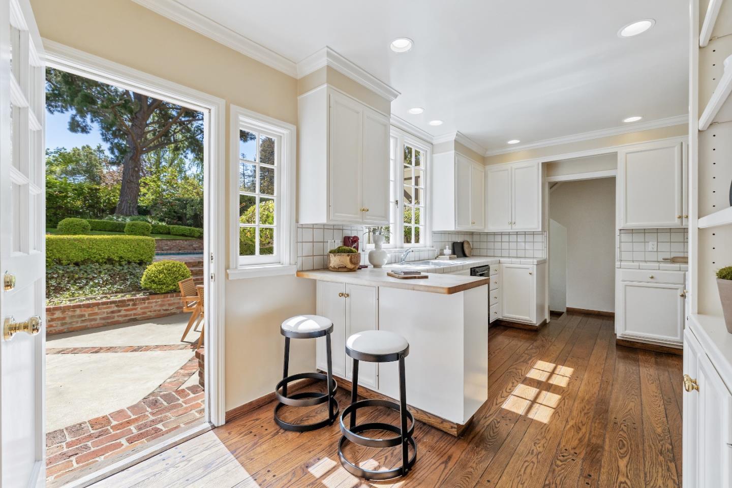 460 Edgewood Road San Mateo, CA 94402 - Photo 10 of 40 a kitchen with a sink a counter top space and stainless steel appliances