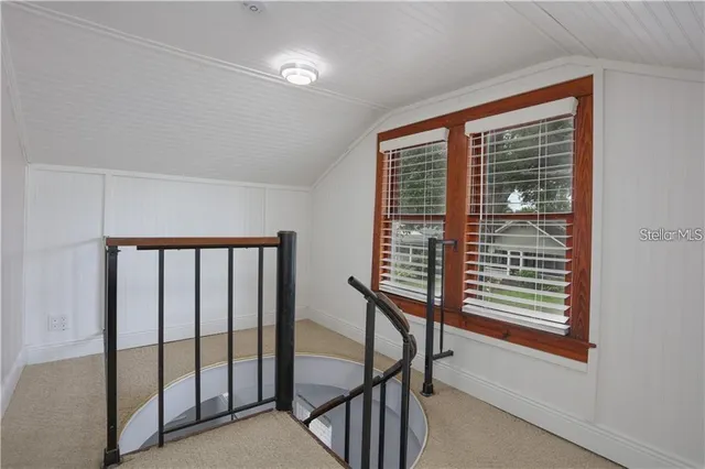 an empty room with closet and windows