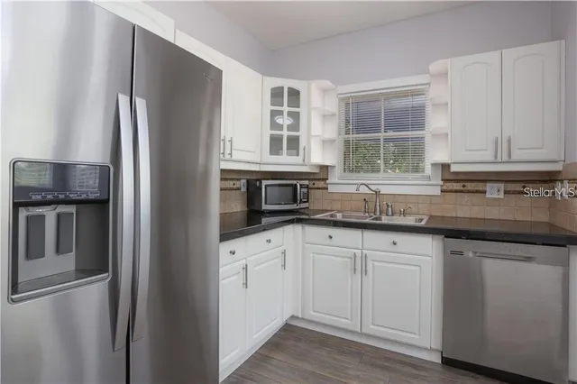 a kitchen with granite countertop stainless steel appliances and counter space