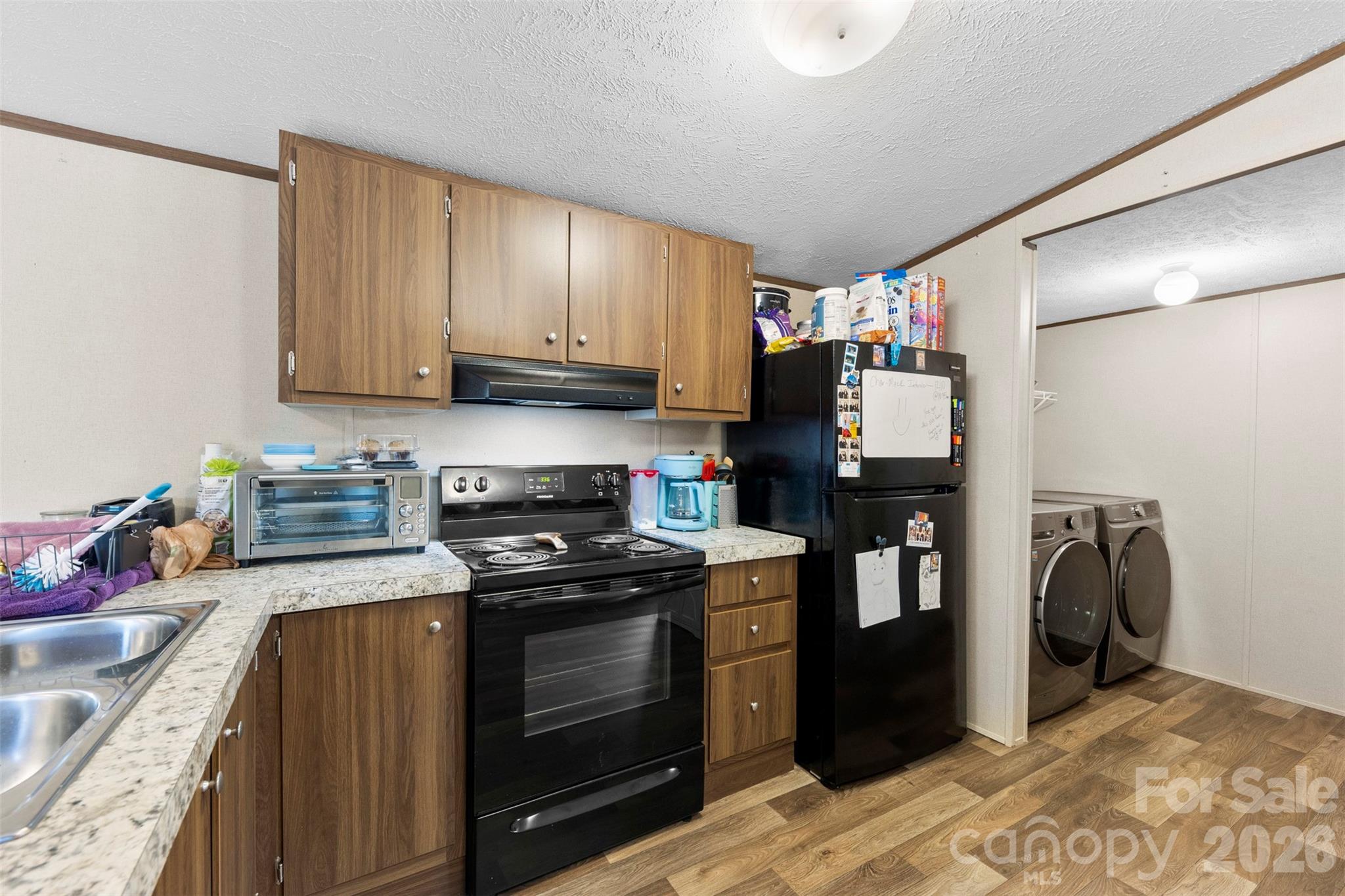 3051 Shoal Road Crouse, NC 28033 - Photo 11 of 26 a kitchen with stainless steel appliances granite countertop a stove a sink and a refrigerator