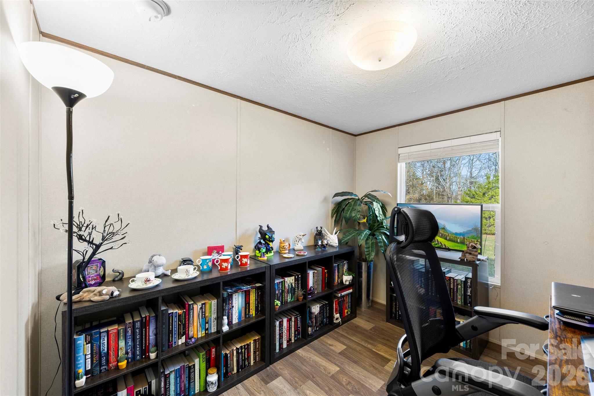 3051 Shoal Road Crouse, NC 28033 - Photo 12 of 26 a living room with lots of furniture and a book shelf