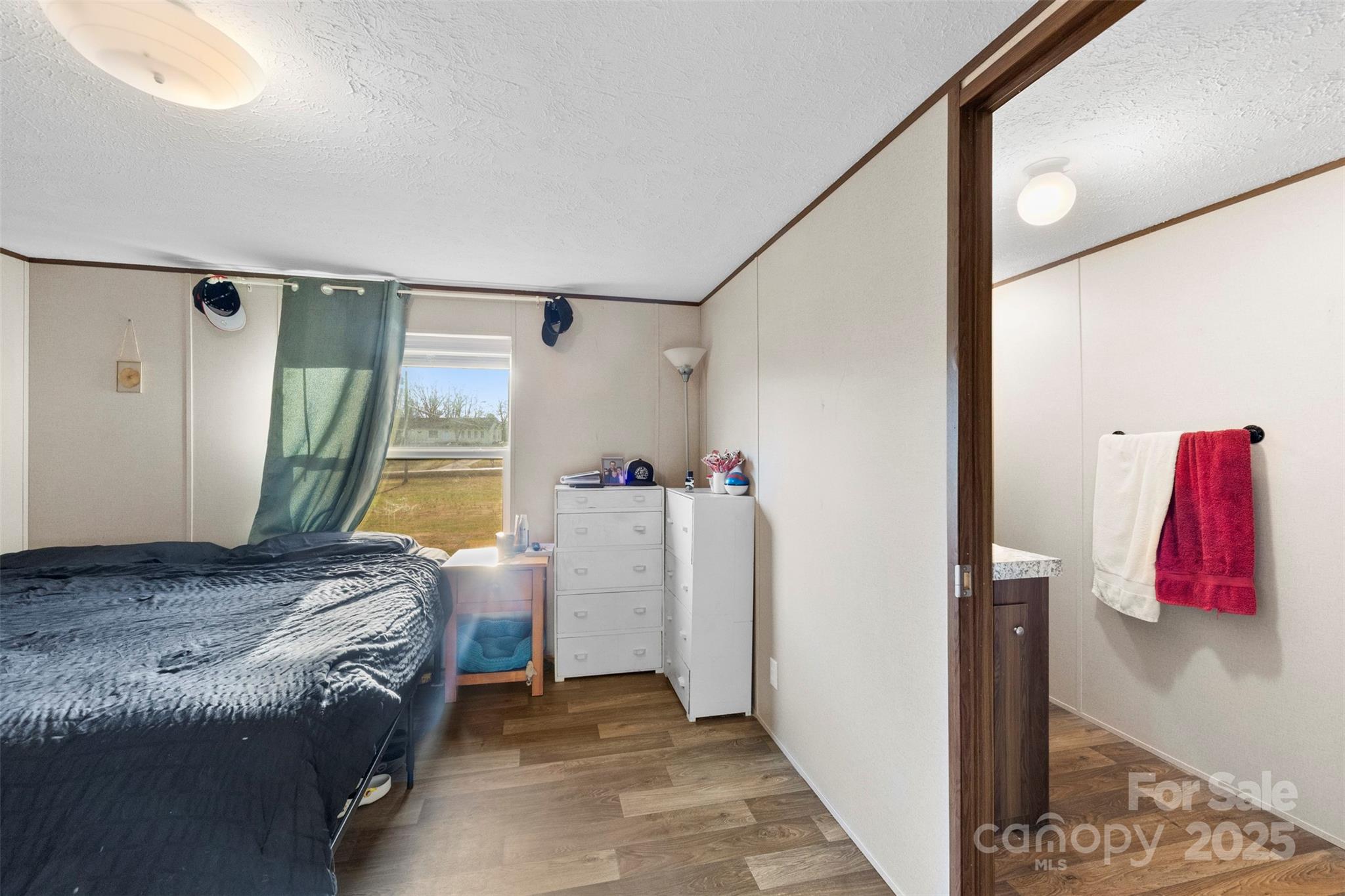 3051 Shoal Road Crouse, NC 28033 - Photo 16 of 26 a bedroom with a bed and a large mirror next to a window