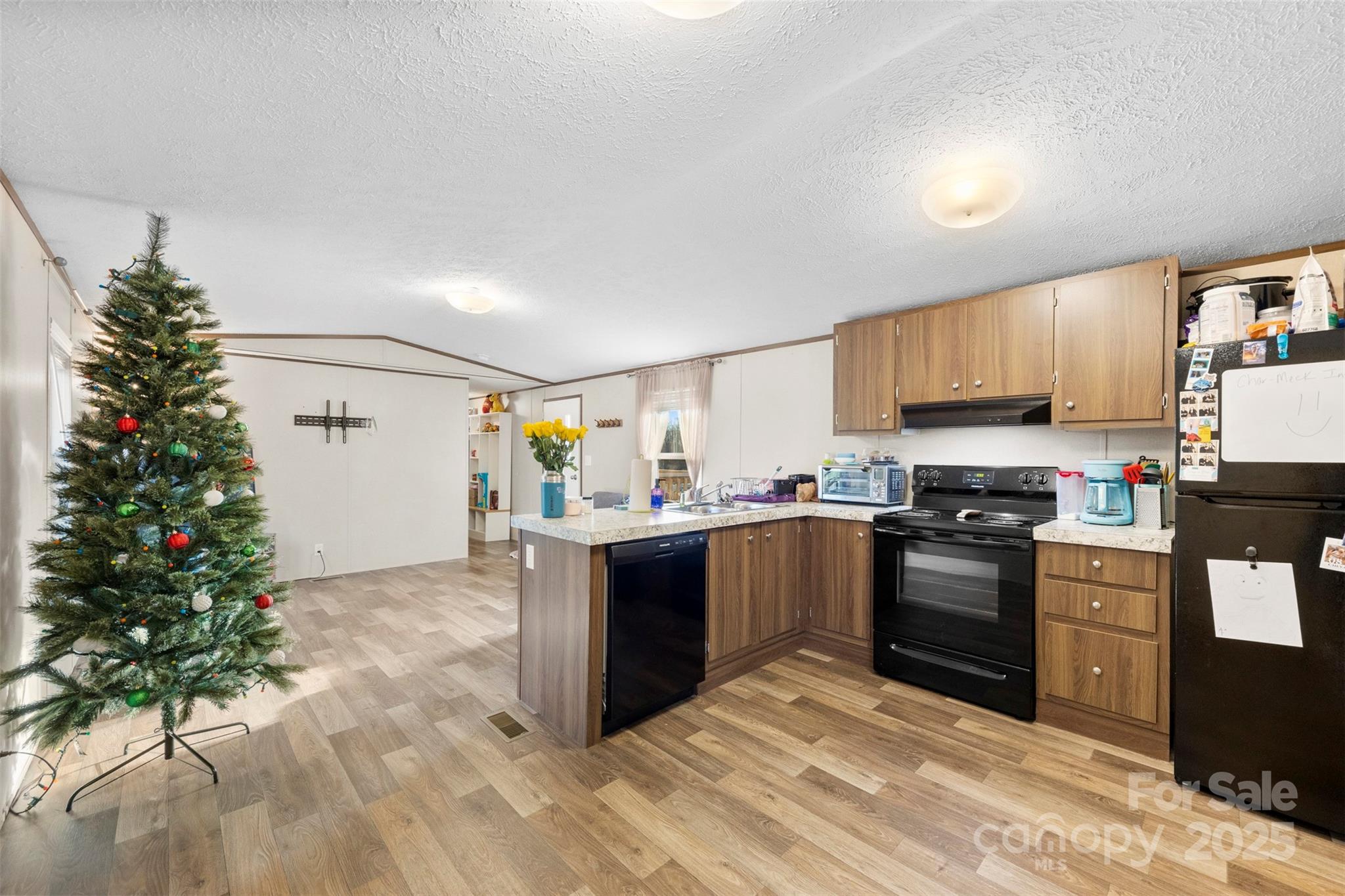 3051 Shoal Road Crouse, NC 28033 - Photo 6 of 26 a kitchen with granite countertop a stove top oven a sink dishwasher and a refrigerator with wooden floor