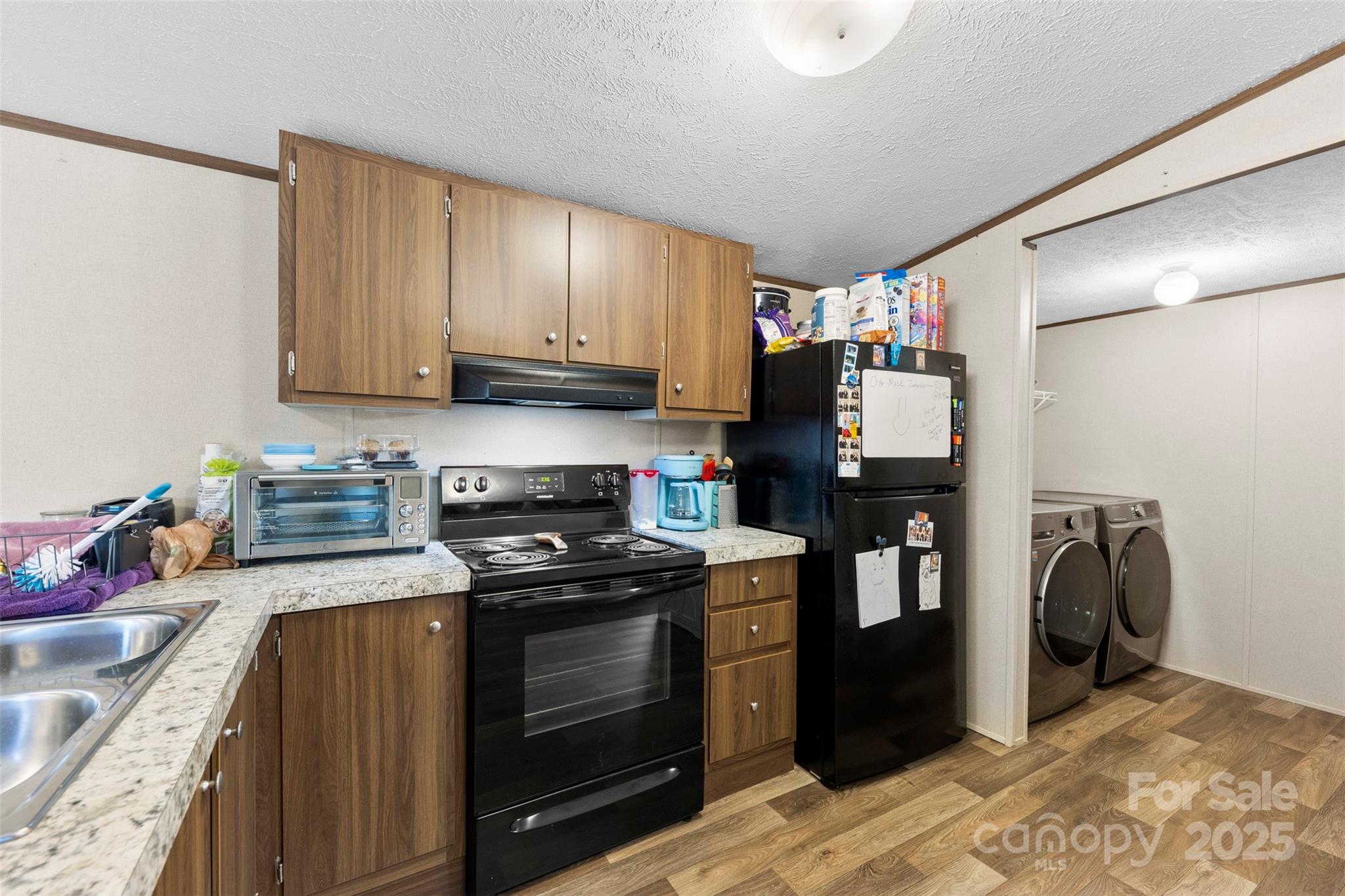 3051 Shoal Road Crouse, NC 28033 - Photo 10 of 26 a kitchen with stainless steel appliances granite countertop a stove a sink and a refrigerator