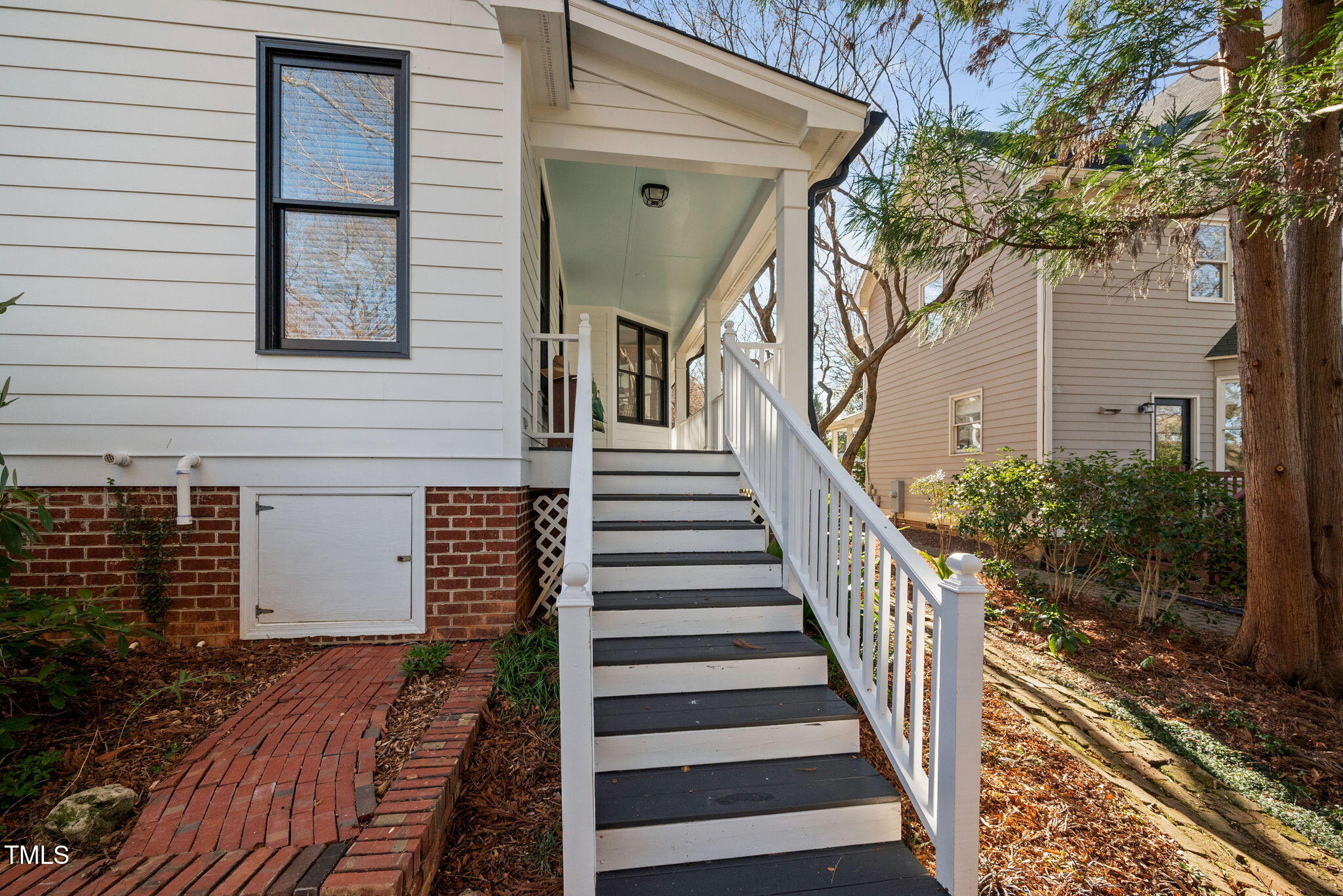 2714 B Clark Avenue Raleigh, NC 27607 - Photo 9 of 38 a view of a house with a large window stairs and wooden floor