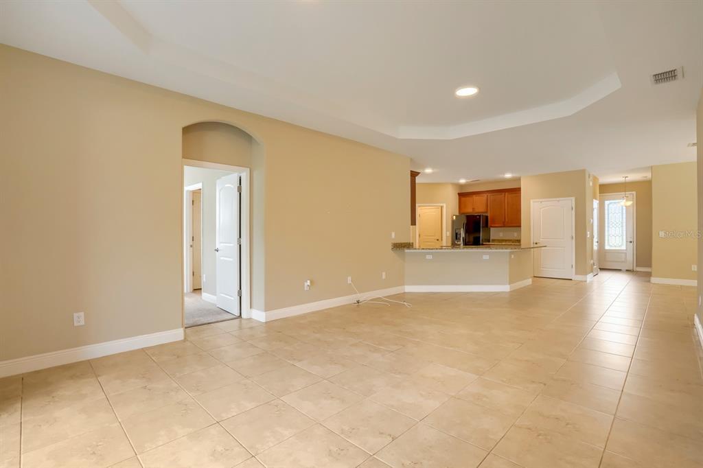 12690 Vander Way New Port Richey, FL 34654 - Photo 4 of 22 a view of an empty room with wooden floor and a window
