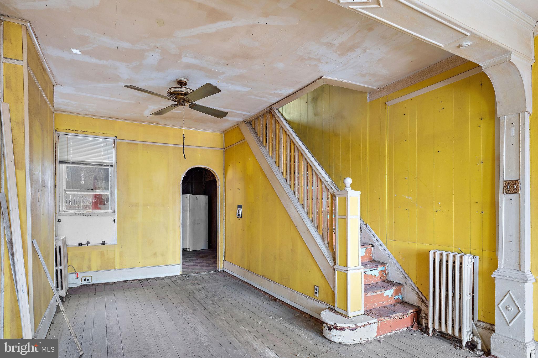 610 Point Street Camden, NJ 08102 - Photo 4 of 23 a view of a hallway with wooden floor and staircase