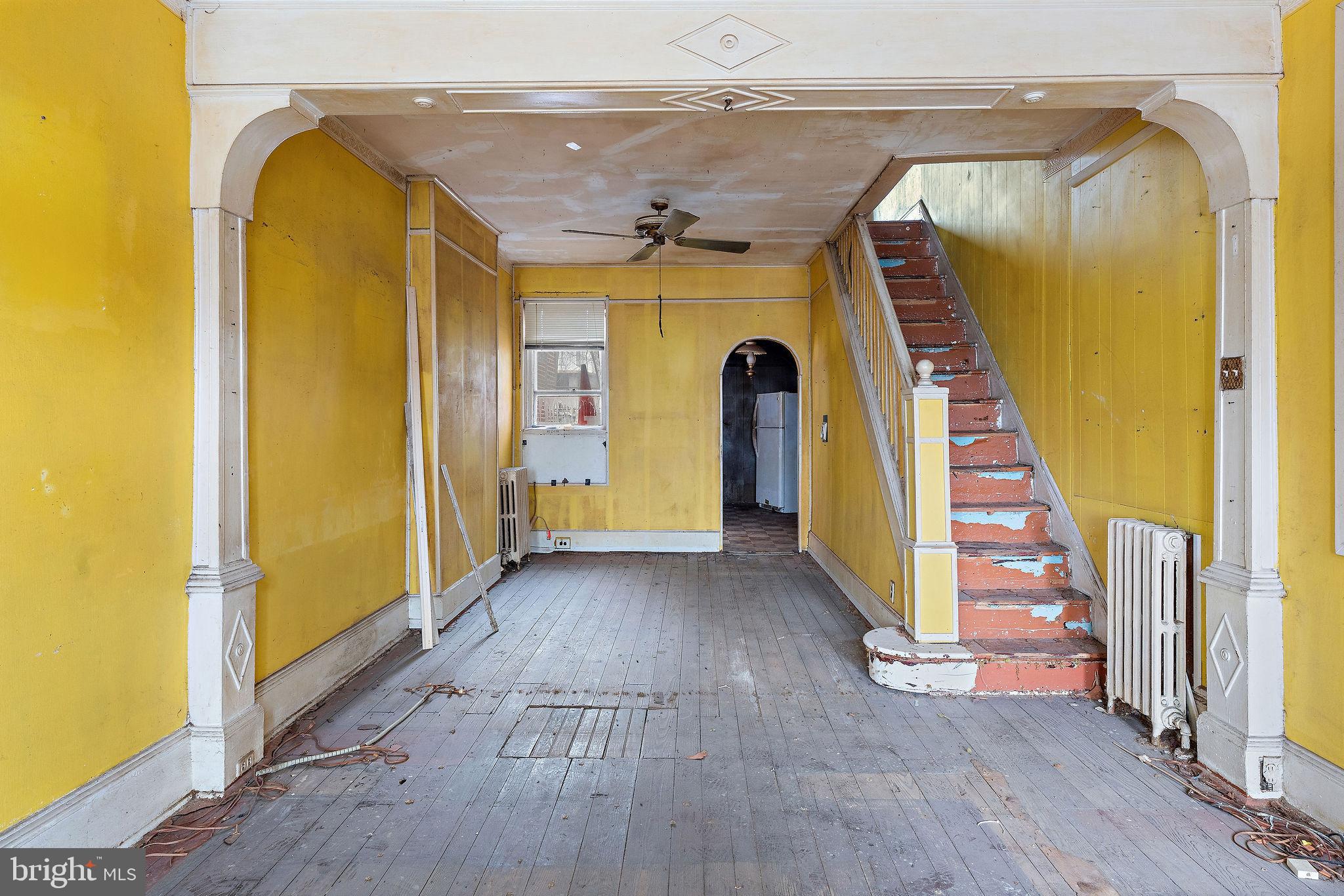 610 Point Street Camden, NJ 08102 - Photo 6 of 23 a view of a hallway with wooden floor and stairs